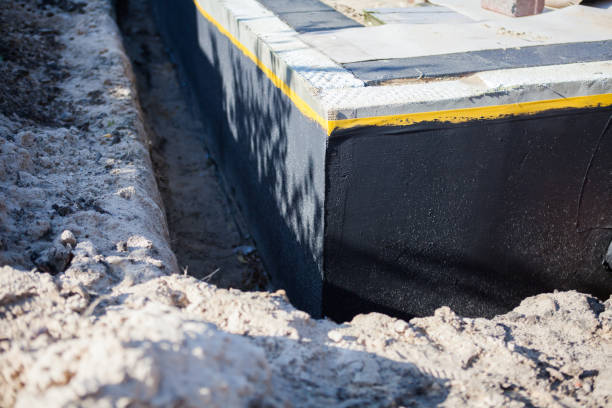 Professional Waterproofing technician working in Olcott, NY
